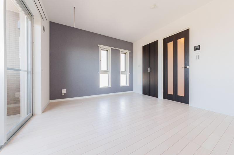 白い床にダークブラウンの建具が映える洗練された雰囲気の洋室